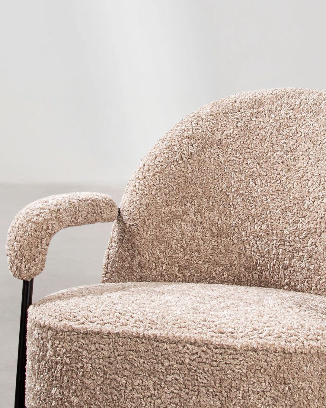 Detailansicht der beigen Stoffpolsterung des modernen Armchairs.